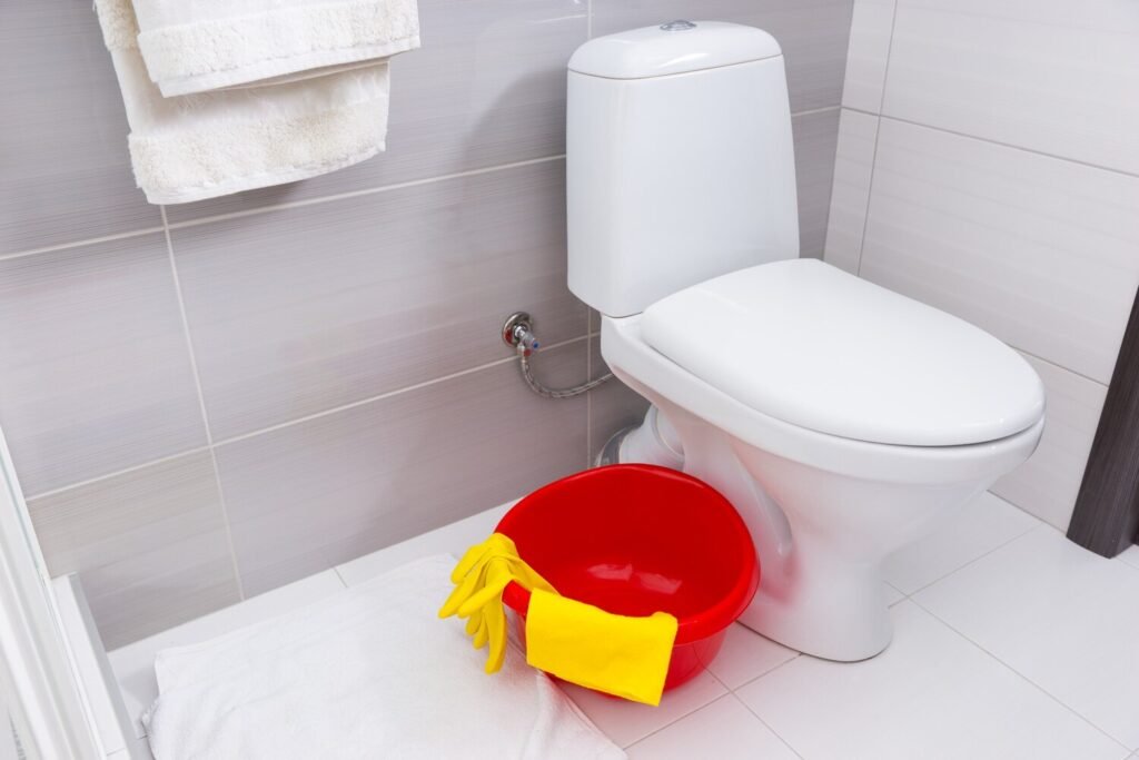 colorful red basin yellow gloves cloth cleaning bathroom standing floor alongside plain white toilet 385506 6110 colorful red basin yellow gloves cloth cleaning bathroom standing floor alongside plain white toilet 385506 6110