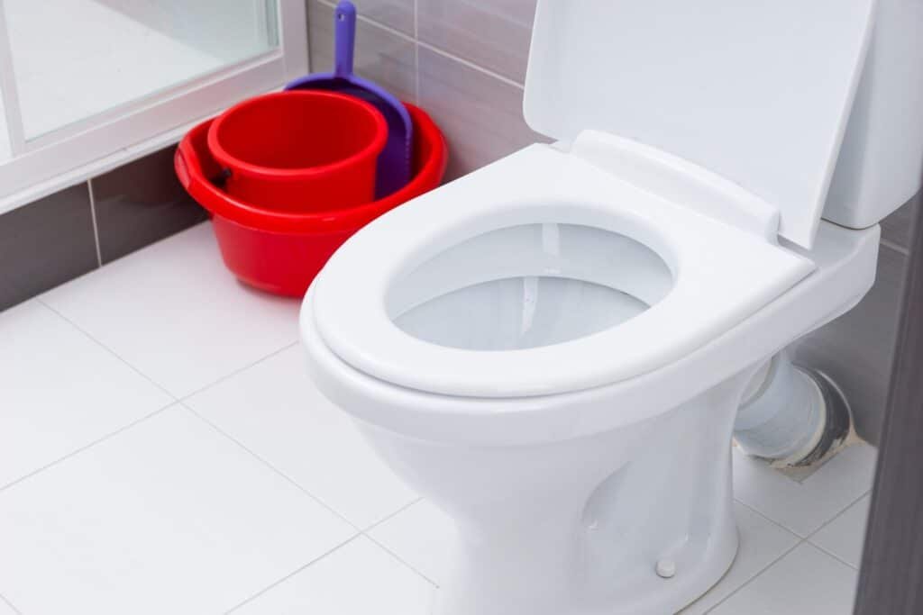 close up open toilet clean bathroom with white gray tiles red cleaning buckets dust pan 385506 5975 close up open toilet clean bathroom with white gray tiles red cleaning buckets dust pan 385506 5975