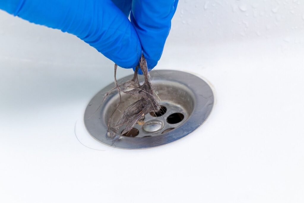 hand glove cleaning clogged sink bathtub drain from hair 157402 2499